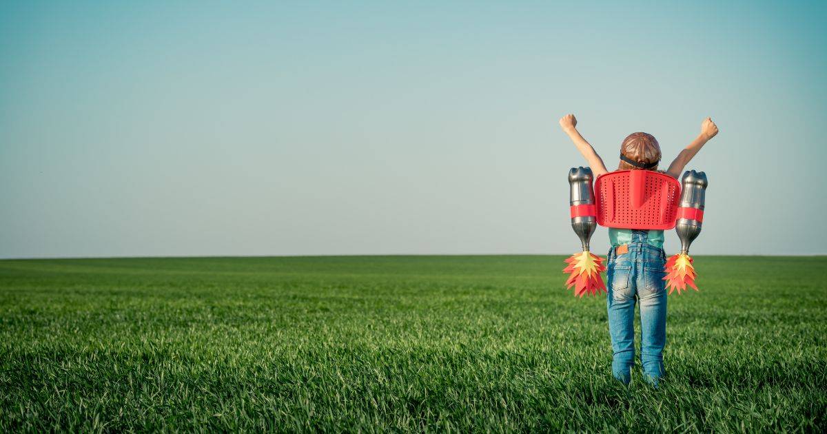 A toy person stood in the field with jetpack bottles rocket.