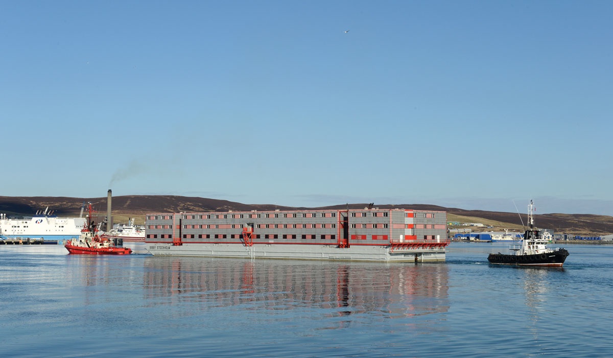 Bibby Stockholm barge being towed into Portland Harbour