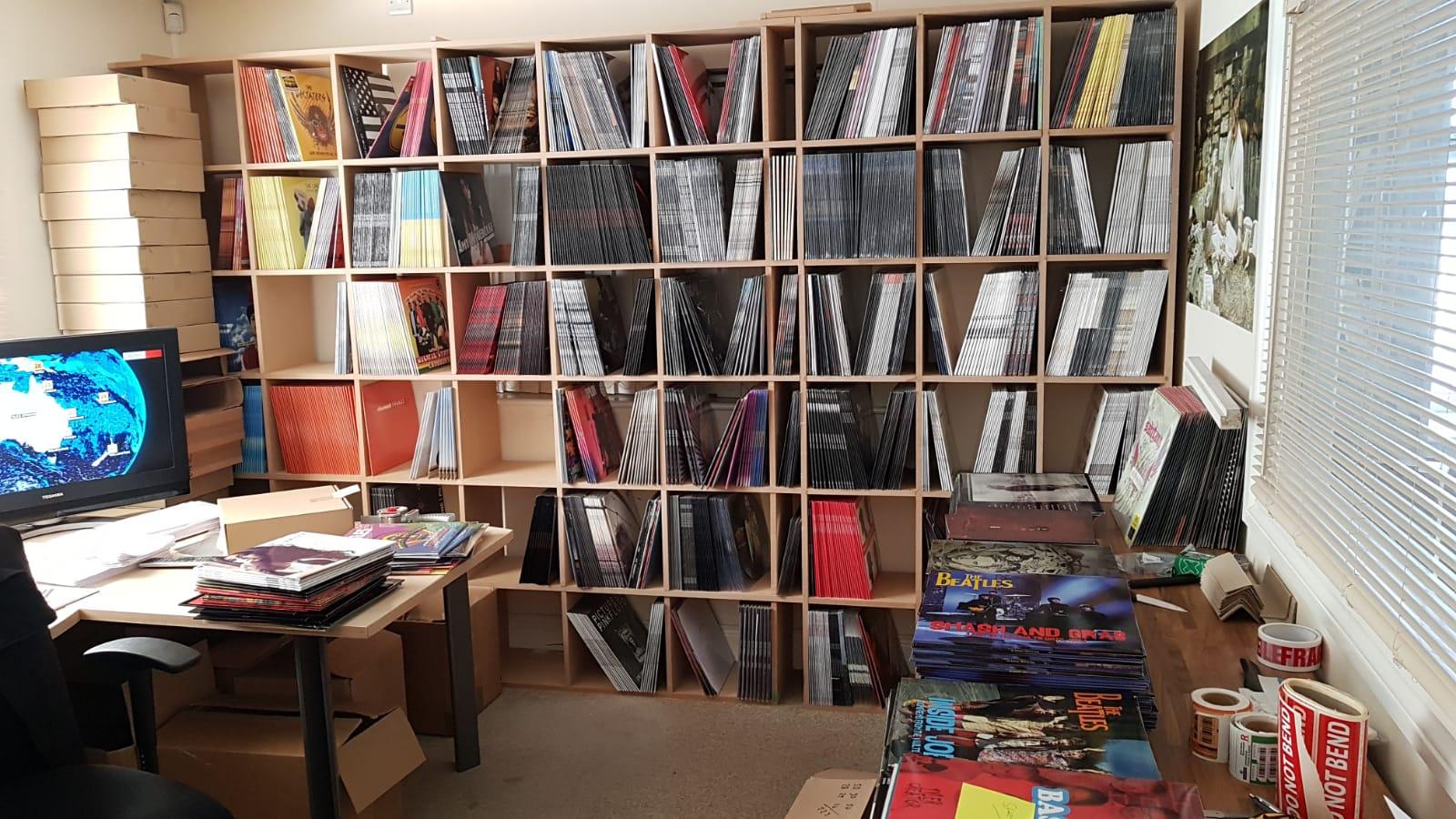 Office with shelves full of counterfeit vinyl records in their sleeves