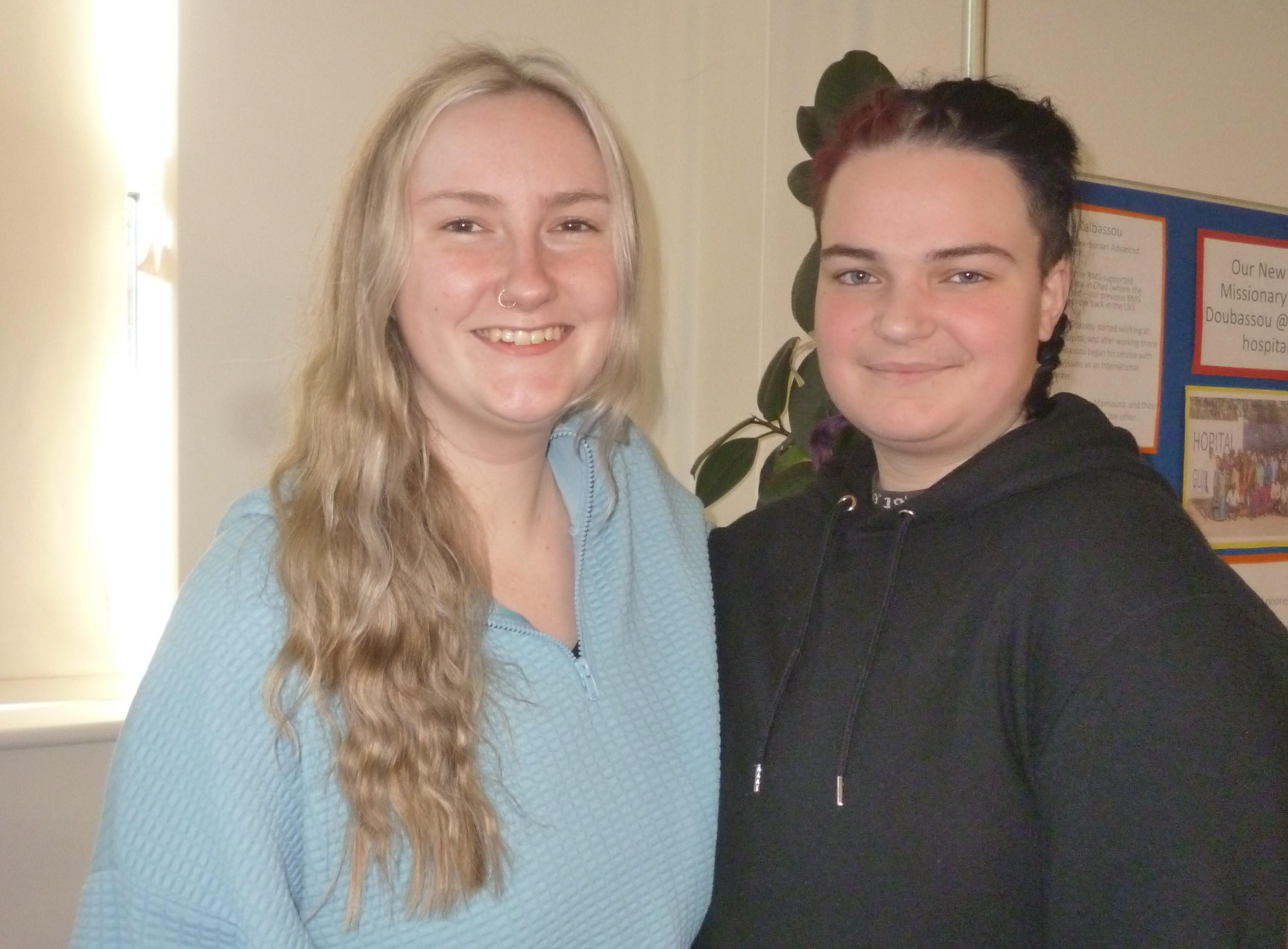 two young people standing side by side