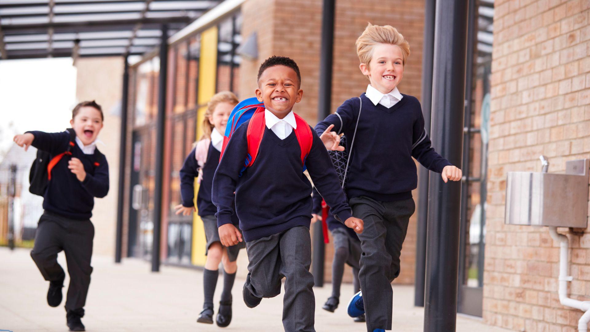 children running in school uniform