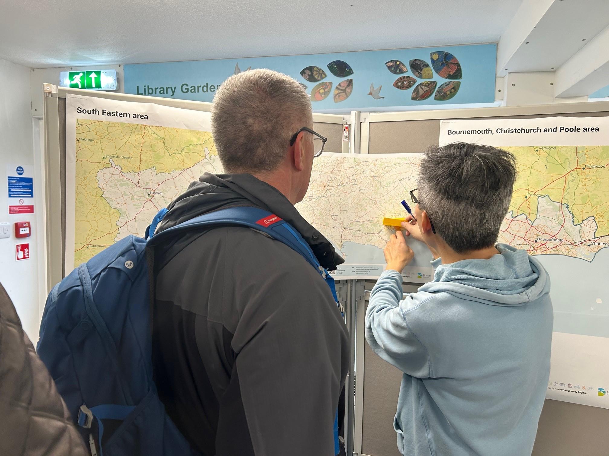 Two people looking at a map on a display board