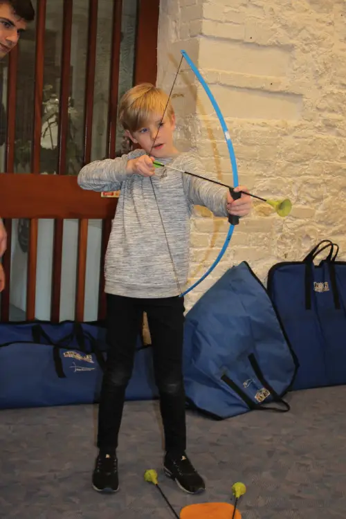 A boy holding a bow and arrow.