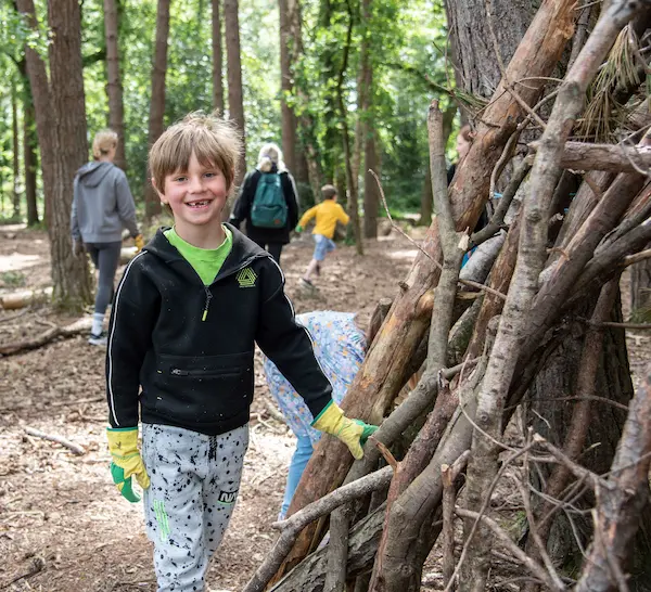 child partaking in activities in the woods