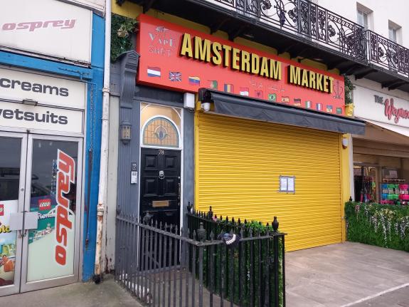 Outside of Amsterdam Market shop in Weymouth, shutters down