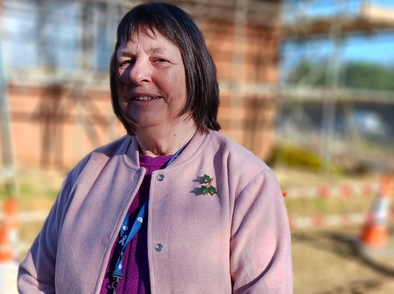 This is an image of the Cabinet member for Health and Housing, outside the Alderholt development site where First Homes are under construction